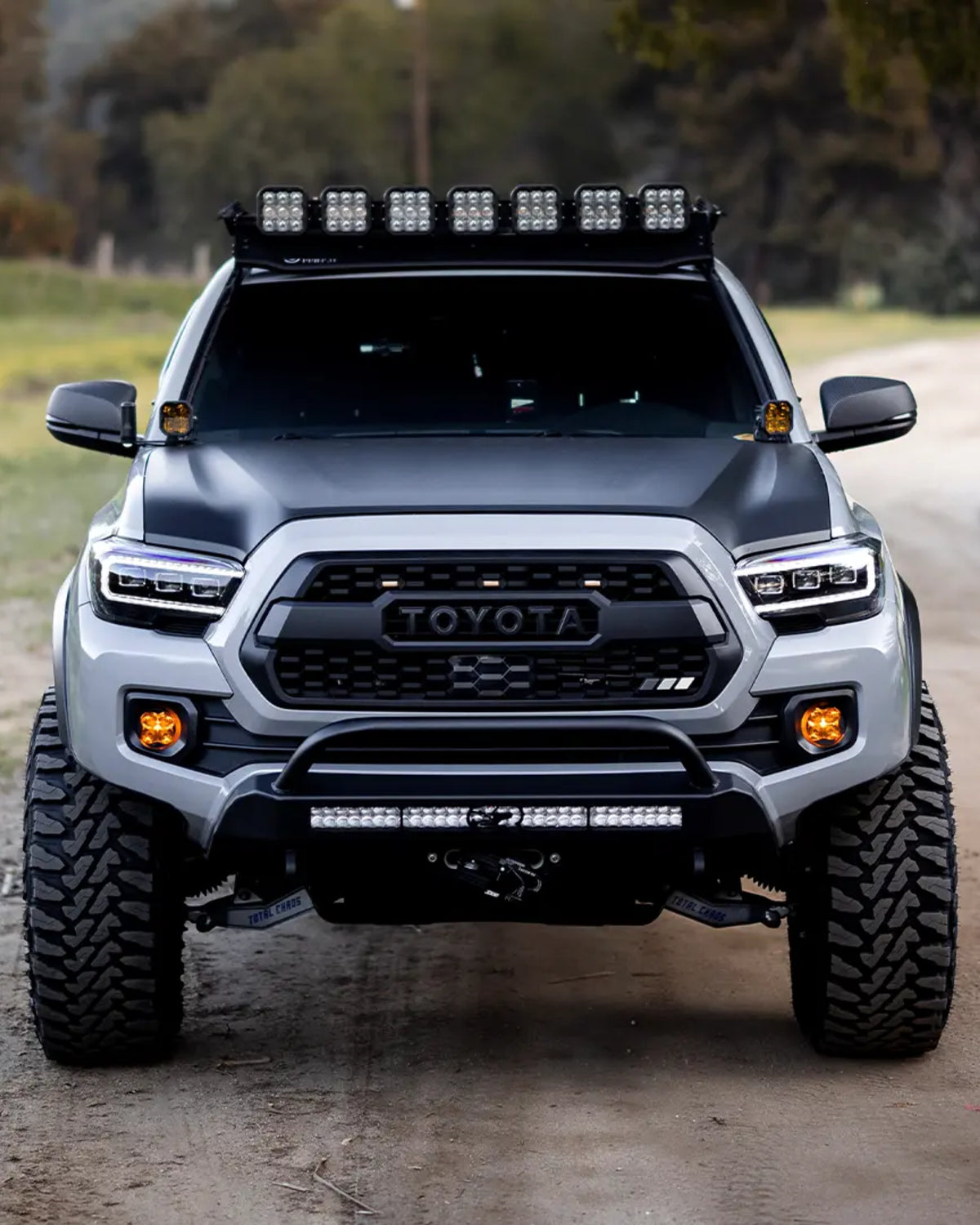 Cali Raised LED Stealth Low-Profile Front Bumper with Bull Bar, Light Bar with Spot Beam Pattern and Clear Lens, and Tall Push-Button Switch for 3rd-Gen Tacoma (2016–2023)