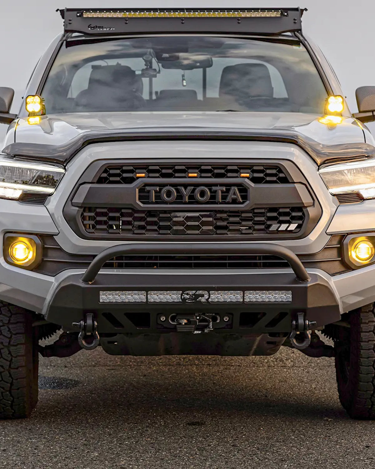 Cali Raised LED Stealth Low-Profile Front Bumper with Bull Bar, Light Bar with Spot Beam Pattern and Clear Lens, and Tall Push-Button Switch for 3rd-Gen Tacoma (2016–2023)